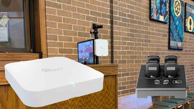 The setup of the Auracast broadcast system via the Ampetronic/Listen Auri transmitter in the church and a superimposed close-up image of the Auri transmitter and receivers in the docking station.