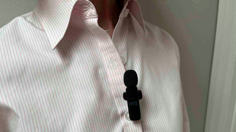 Photo of a remote mic clipped to a dress shirt