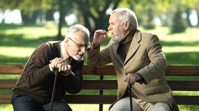Senior Men On Parkbench Hearing Loss