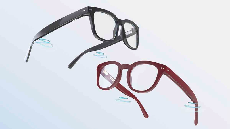 Six microphones (the three silver ports on each side of the glasses) gather and process the sound, then deliver it to the ears via receivers near the back of the temples. The hearing glasses are currently available in two sizes and two colors (shiny black and burgundy). Photo courtesy of Nuance Audio.