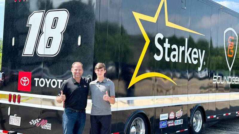 Brandon and William Sawalich in front of the Joe Gibbs Racing/Starkey/SoundGear race hauler.