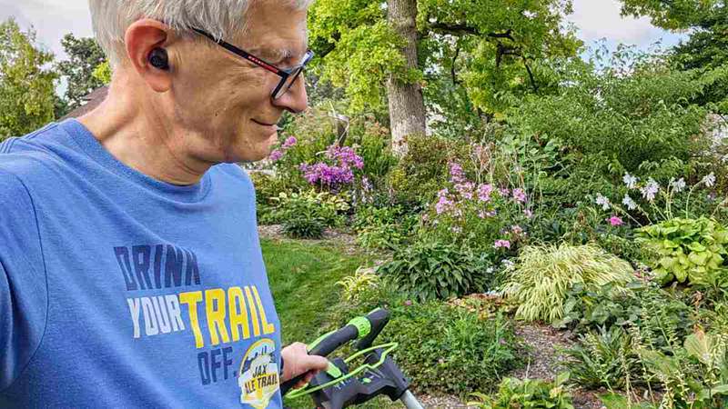 Hearing care expert Andrew Bellavia, who wears hearing aids for his severe hearing loss, is shown here wearing noise-cancelling earbuds with personalization for listening to music.