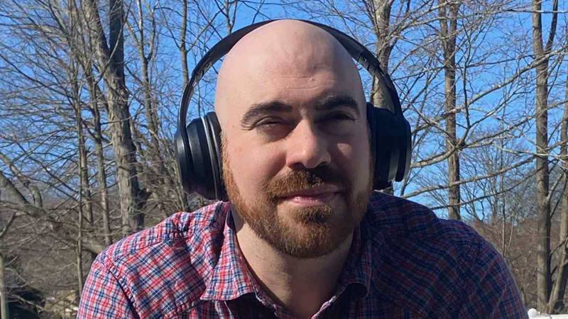 Yuni Founder Dan Glass with headphones on outdoors
