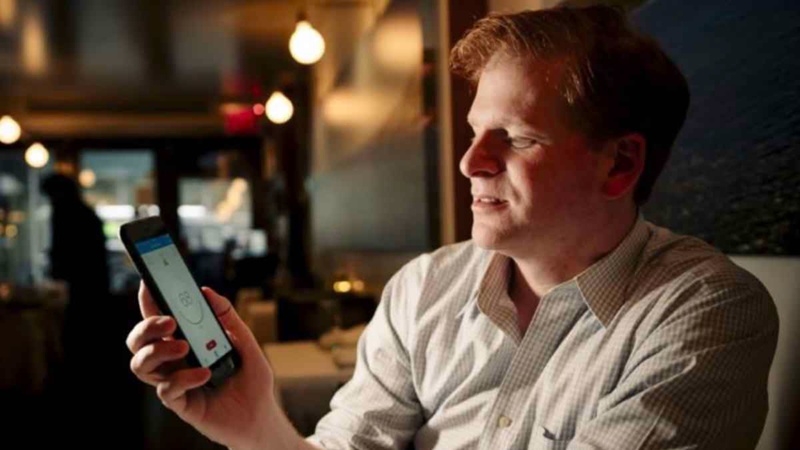 Gregory Scott measures the sound level at a restaurant using the SoundPrint app.